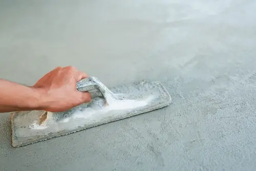 Technician fixing slanted floors during interior floor leveling in Kingsport, TN to restore a stable walking surface